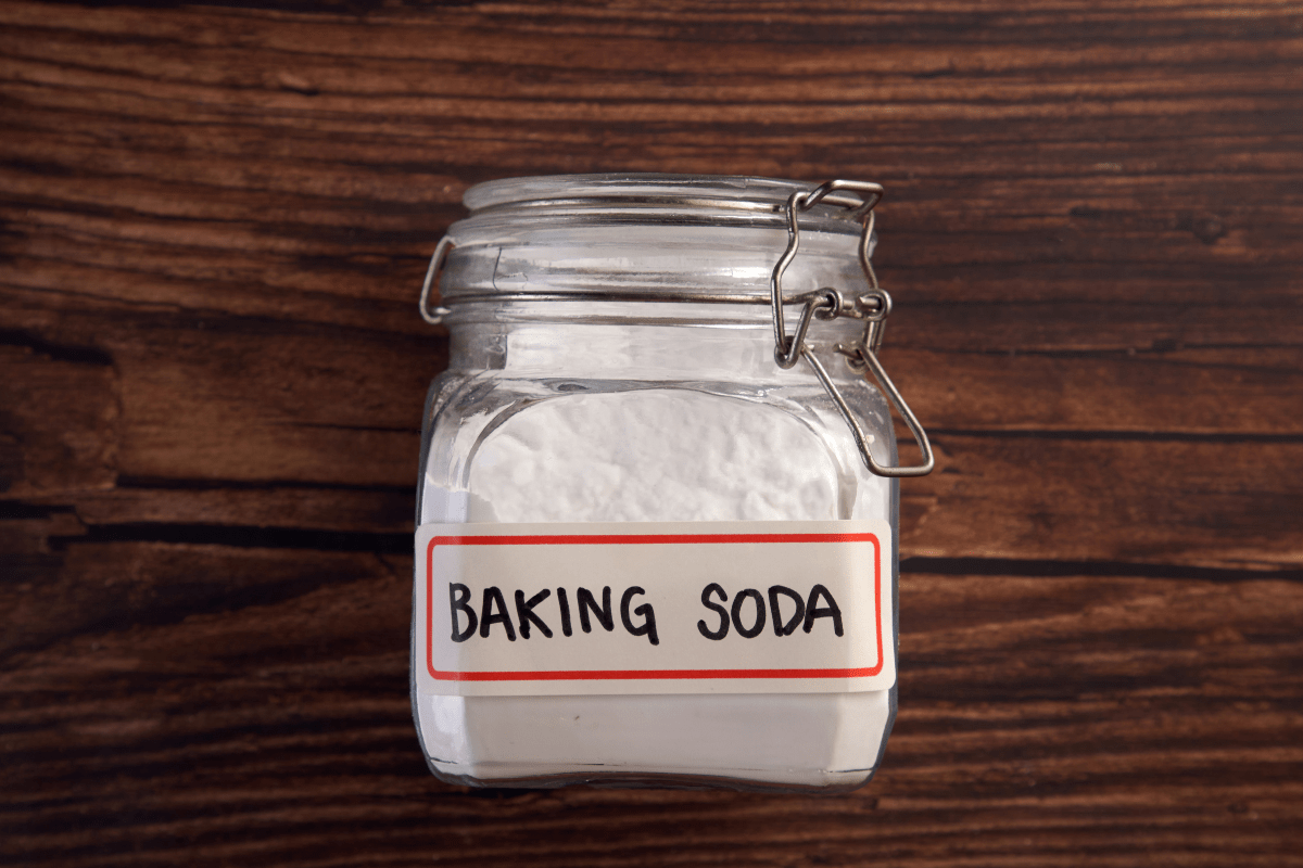 jar of baking soda on wood background