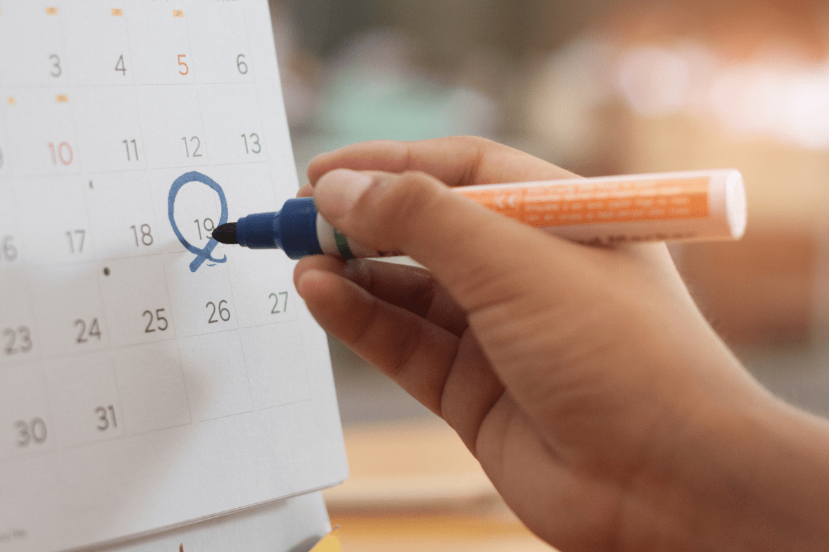 close up of hand marking of 19th day on calendar