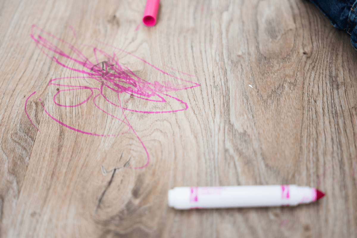 pink marker on wood plank vinyl flooring