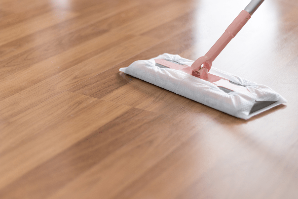 close up of swiffer mop on wood vinyl plank flooring