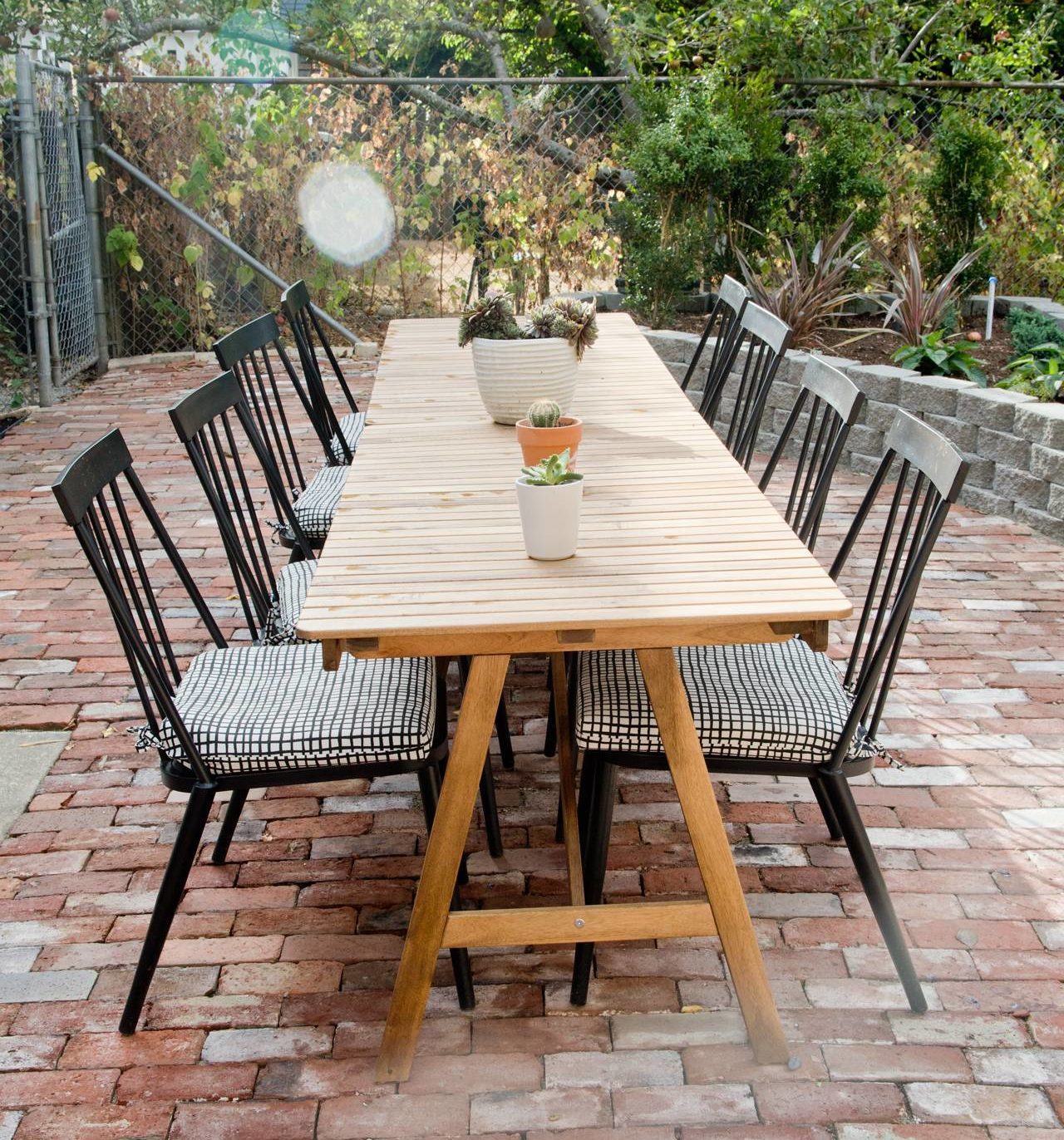 outdoor dining room table set on red brick patio