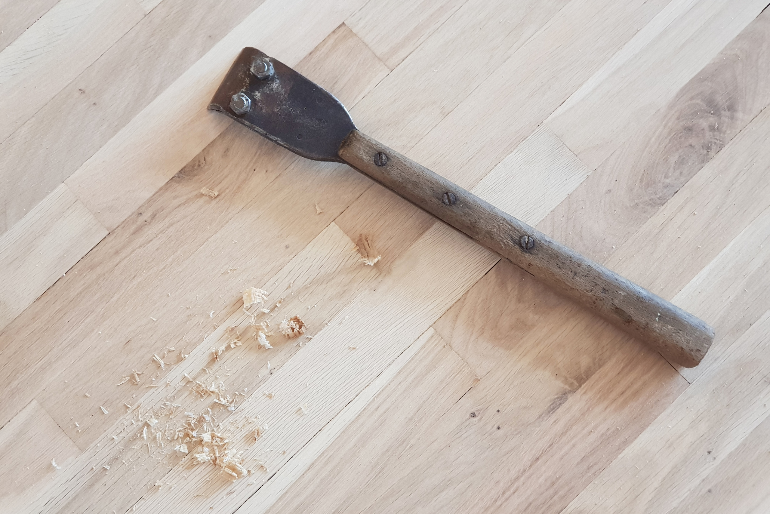 Scraping tool on wood floor.