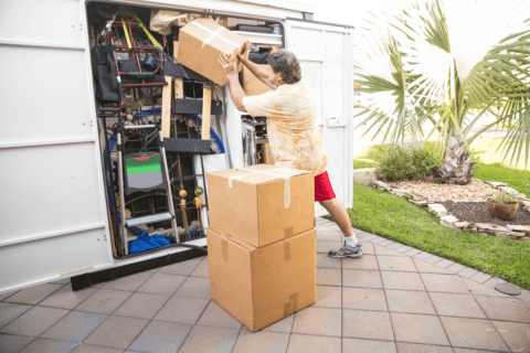 person loading up open moving van