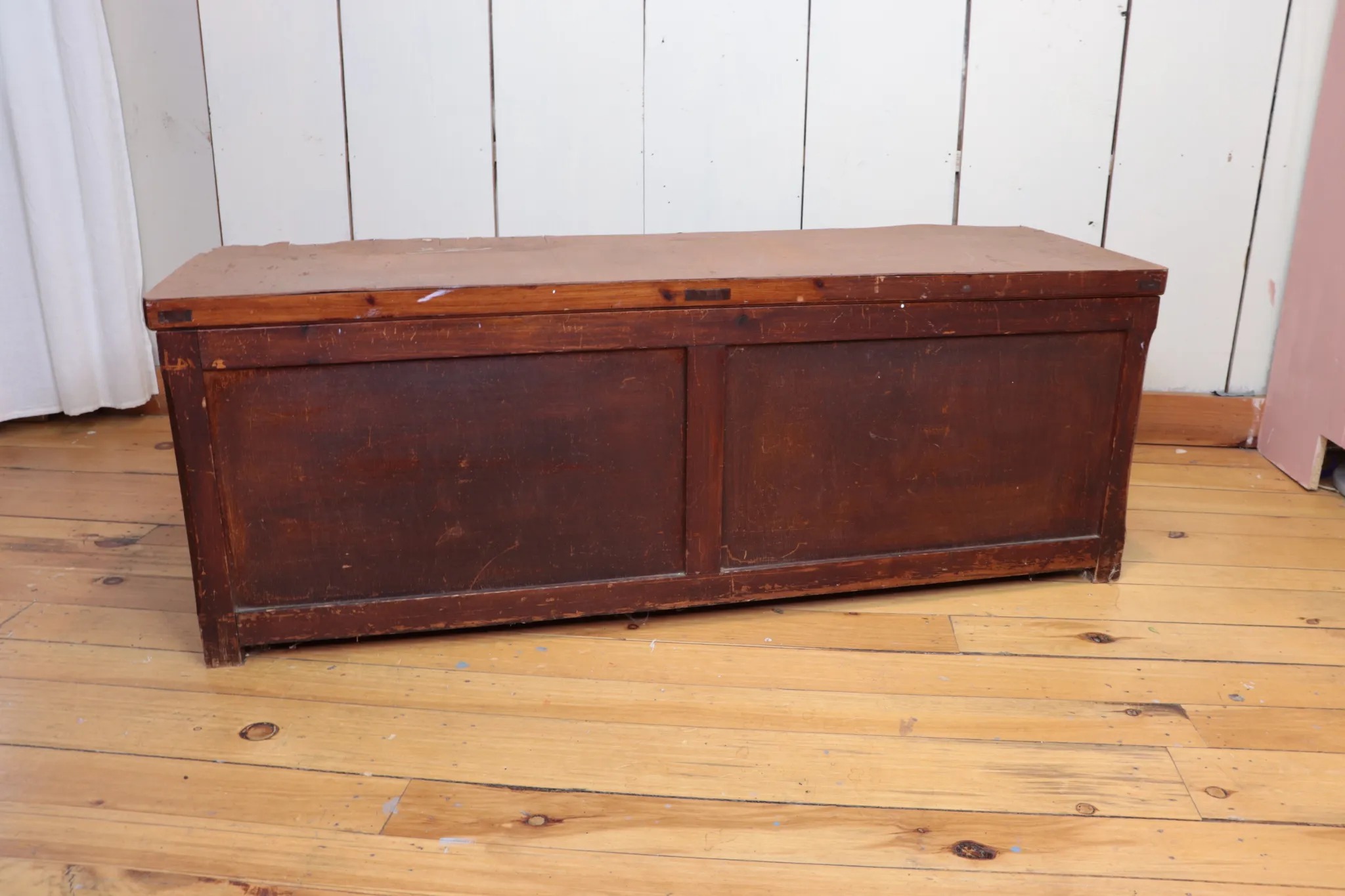 scraped wooden chest bench on wood floor