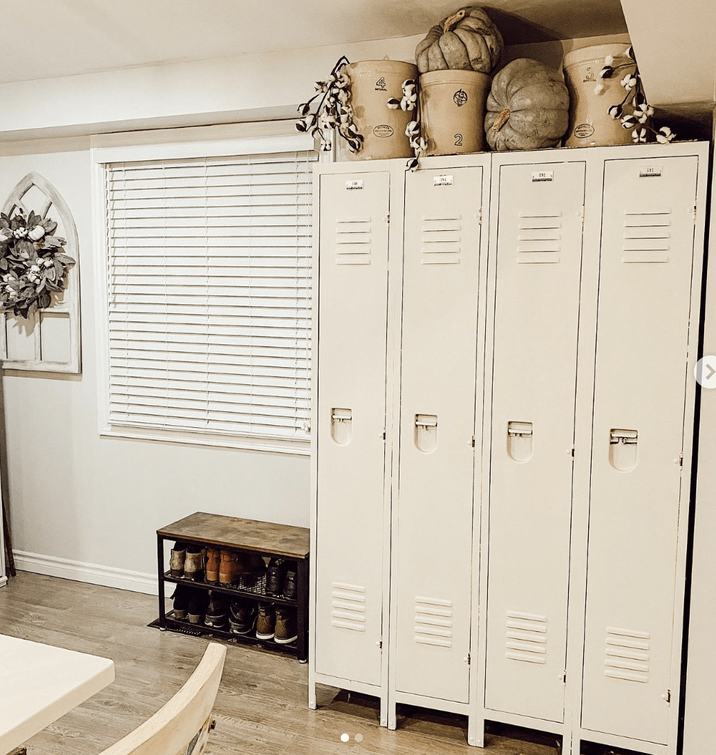 vintage cream colored standing lockers wit bins and pumpkins stored on top