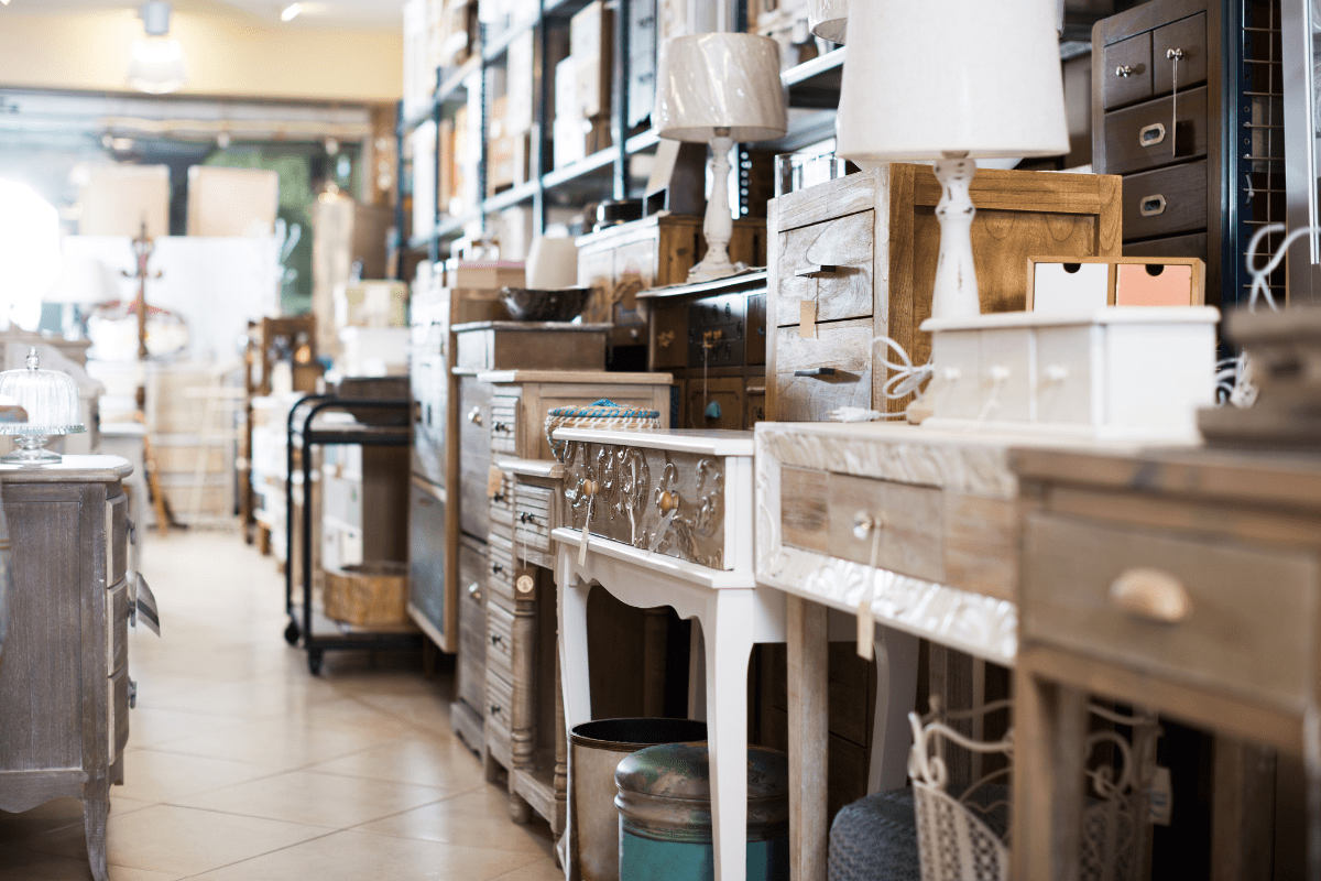 wooden tables and lamps displayed in second hand furniture store