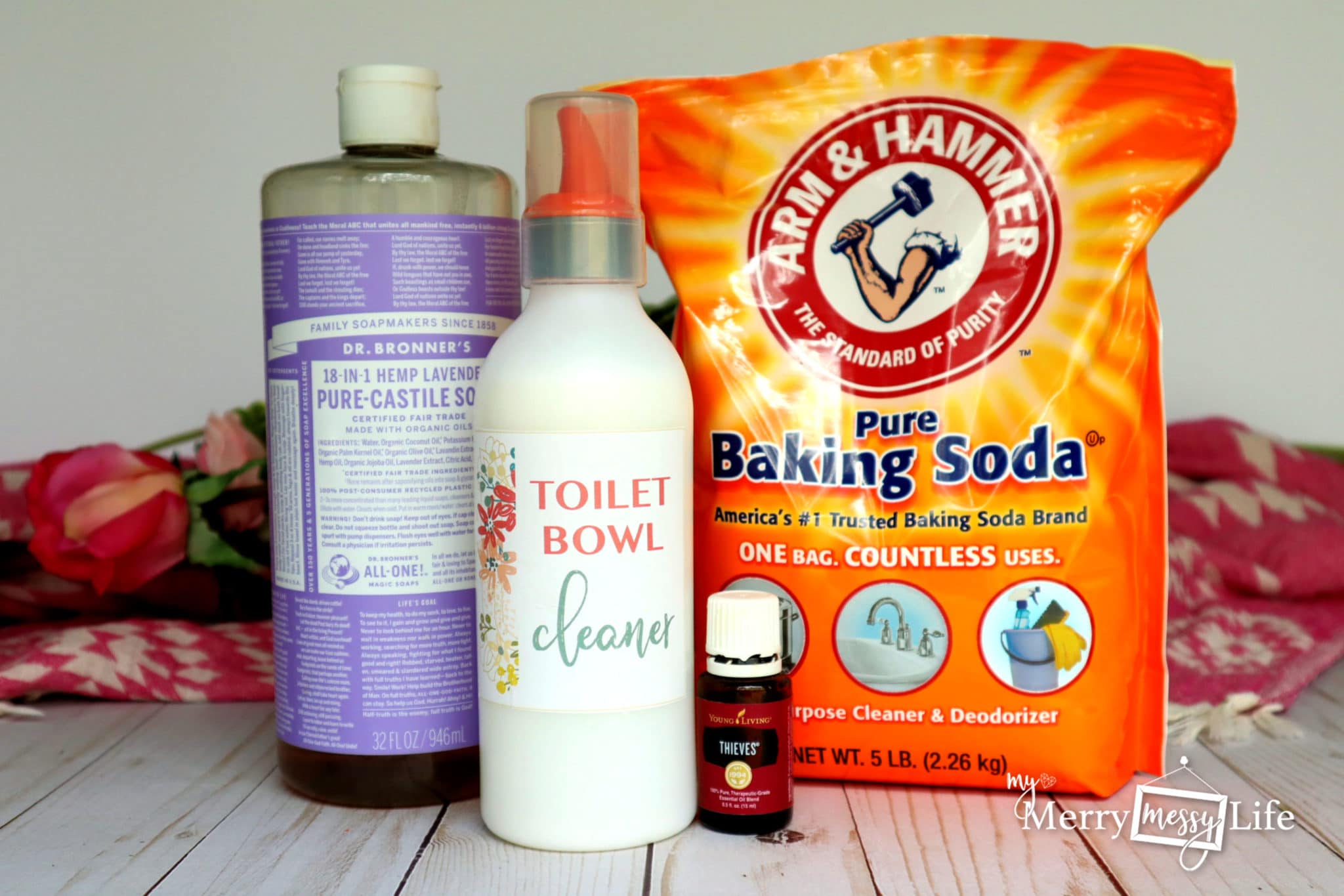 pure baking soda, castile oil, essential oil lined up to make toilet bowl cleaner