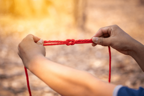 close up of person holding knot