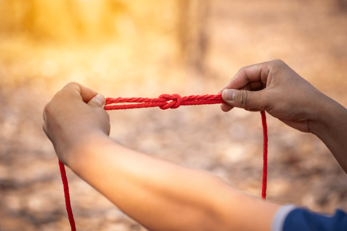 close up of person holding knot