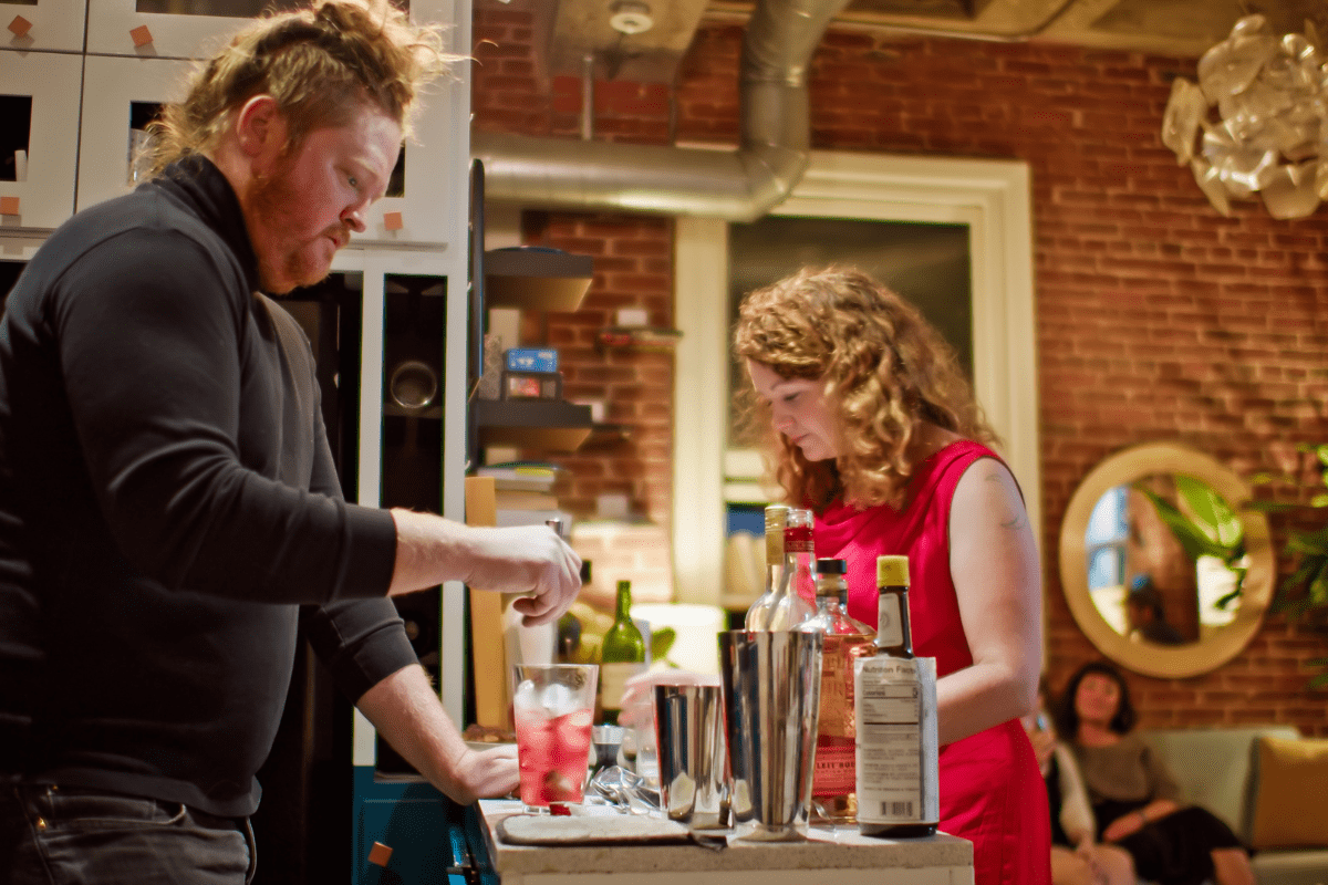 man and woman at an at home bar making drinks