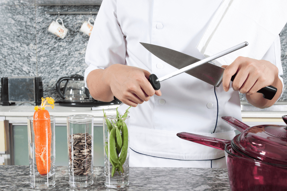 knife sharpening close up chef in kitchen