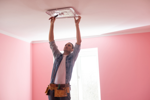 electrician installing a light fixture