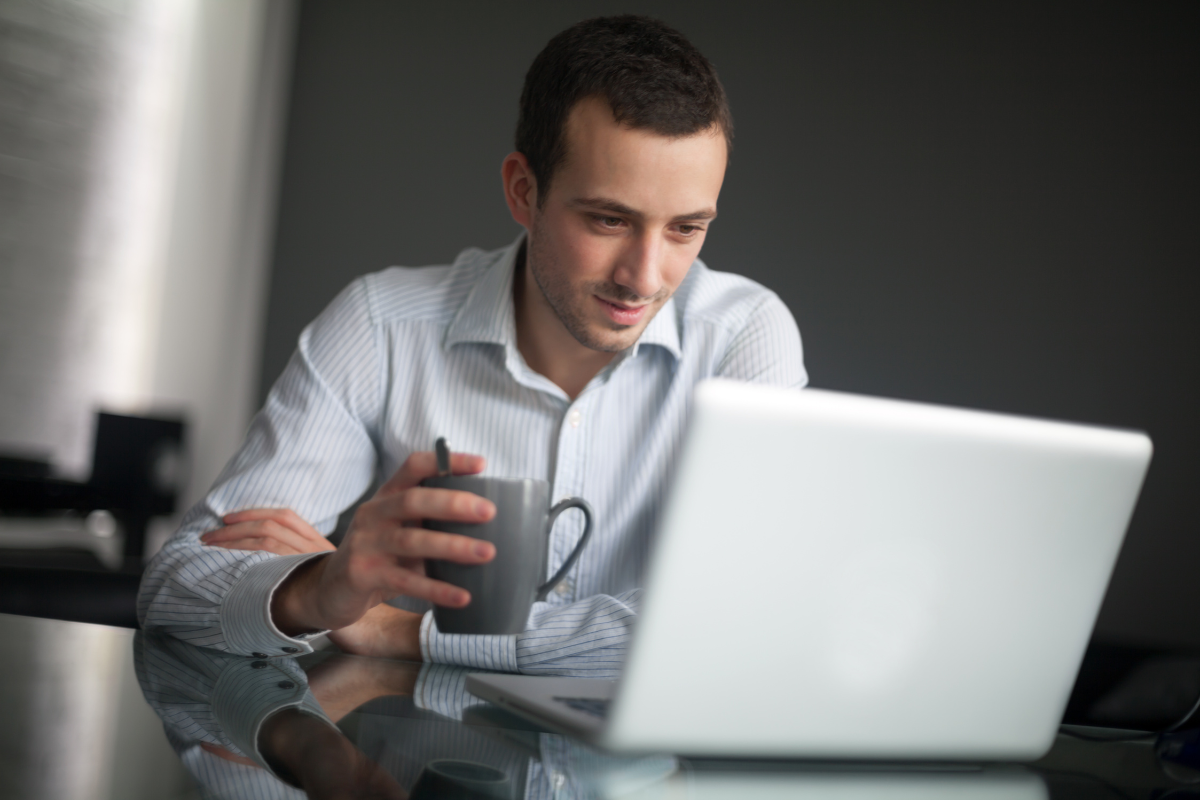 man reading on a computer