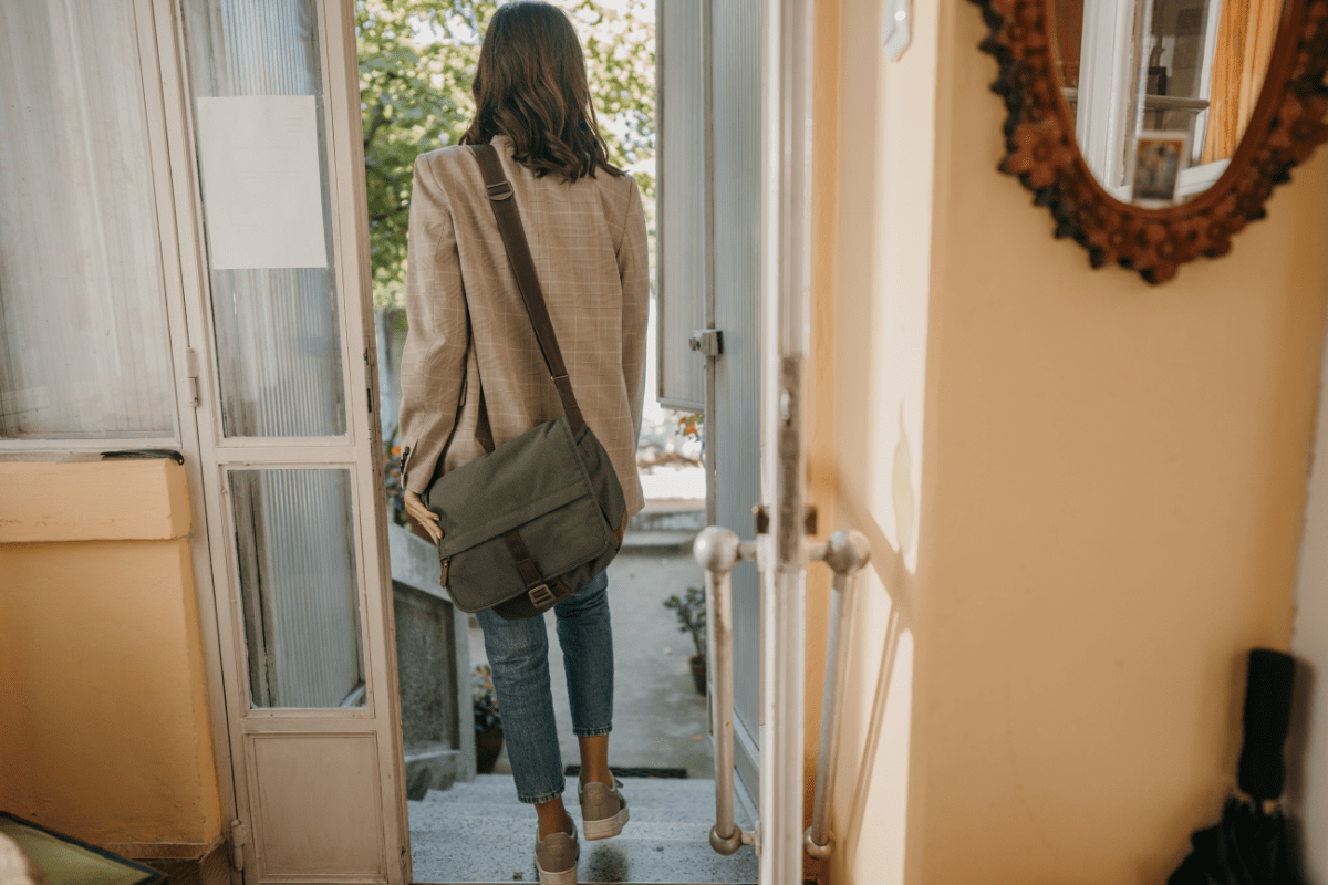 woman leaving home with bag