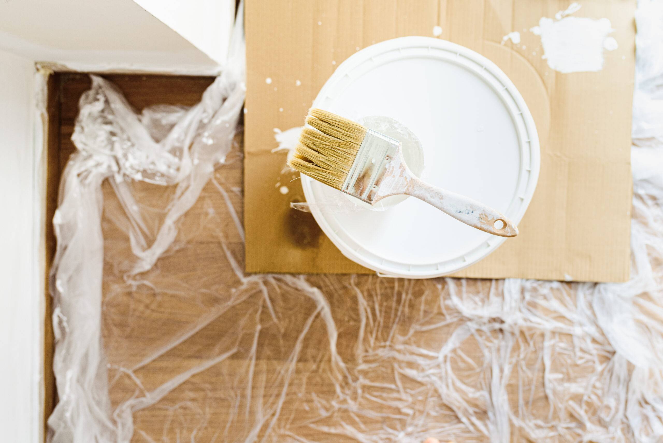 White paint without gas emissions on a bucket of ecological plastic paint to decorate the house.