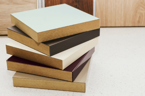 A stack of laminated MDF samples in varying colors
