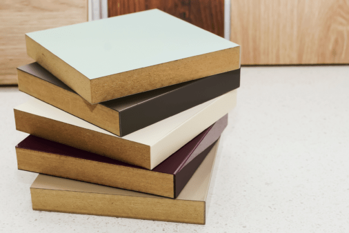 A stack of laminated MDF samples in varying colors