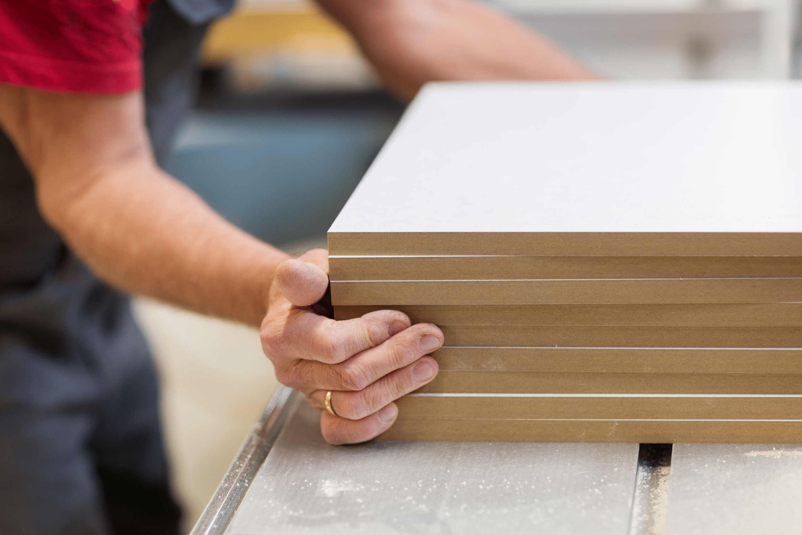 Worker grabbing onto MDF board stack