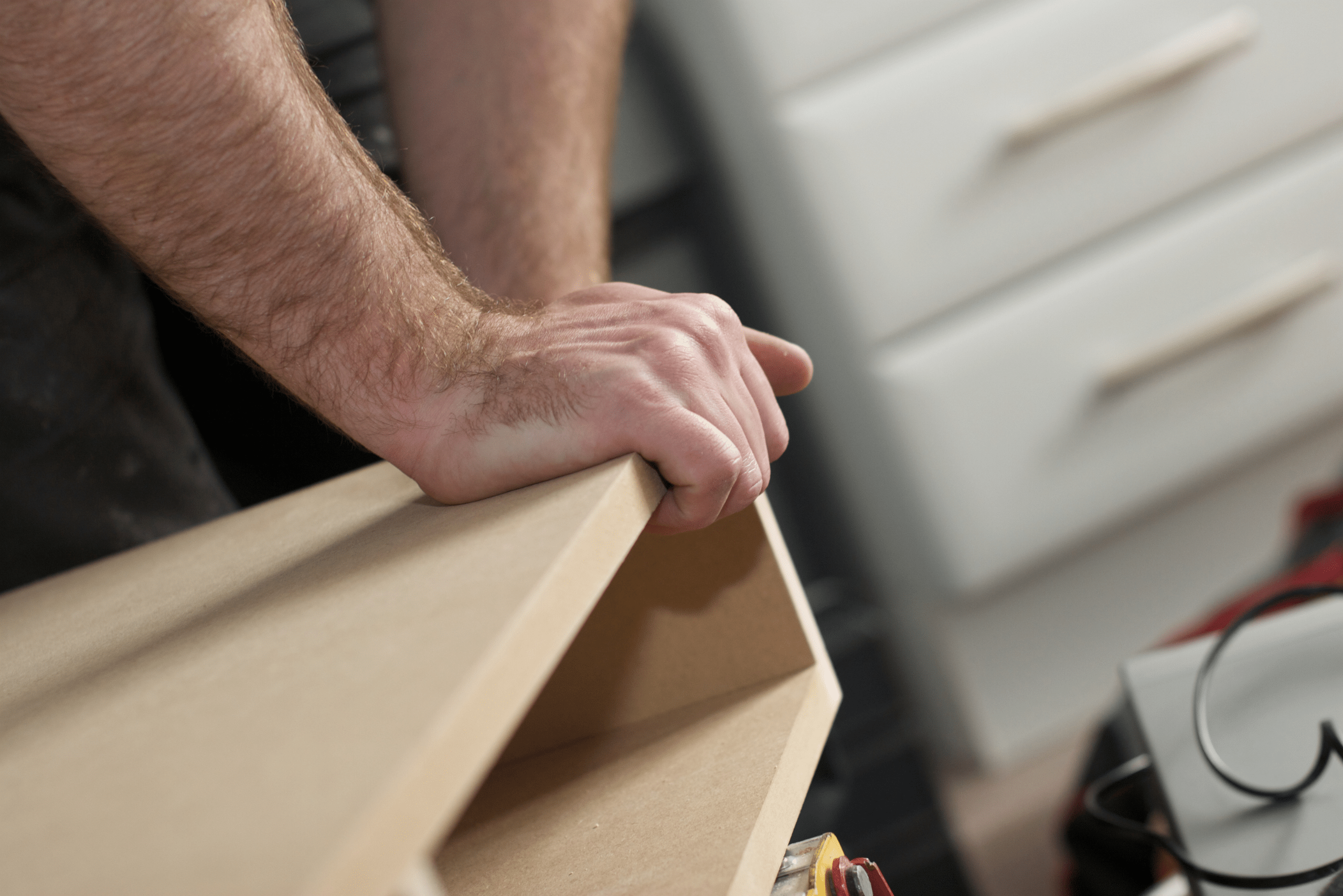 Carpenter fixing MDF board for cabinet