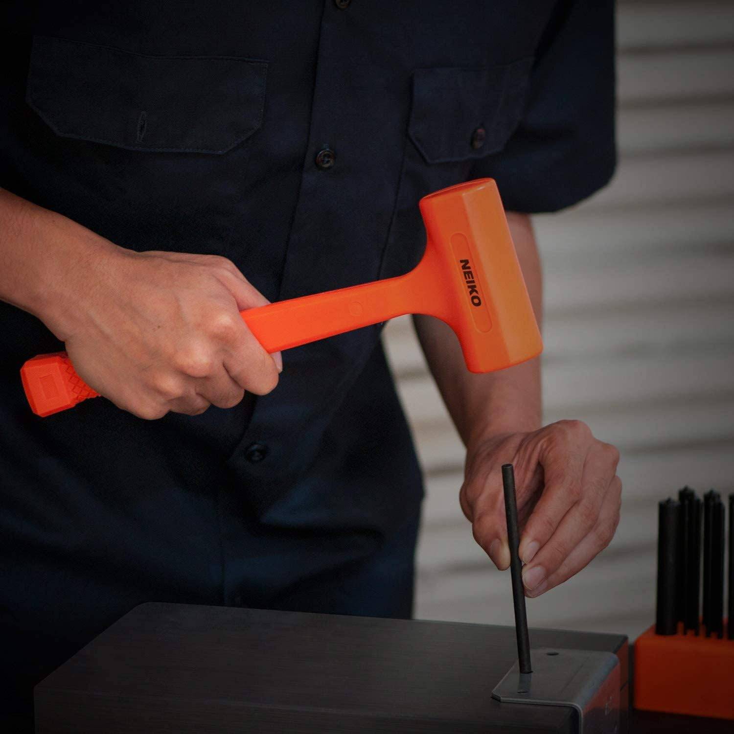 Man hammering with a bright orange dead blow hammer