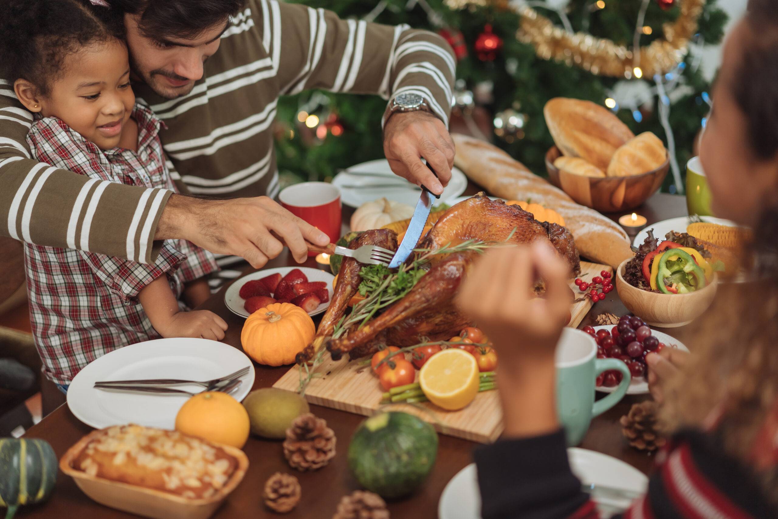 Happy family celebrating Thanksgiving dinner at home.