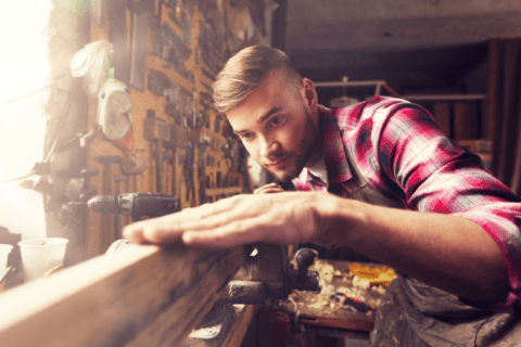 Person working on a piece of wood to make it perfect