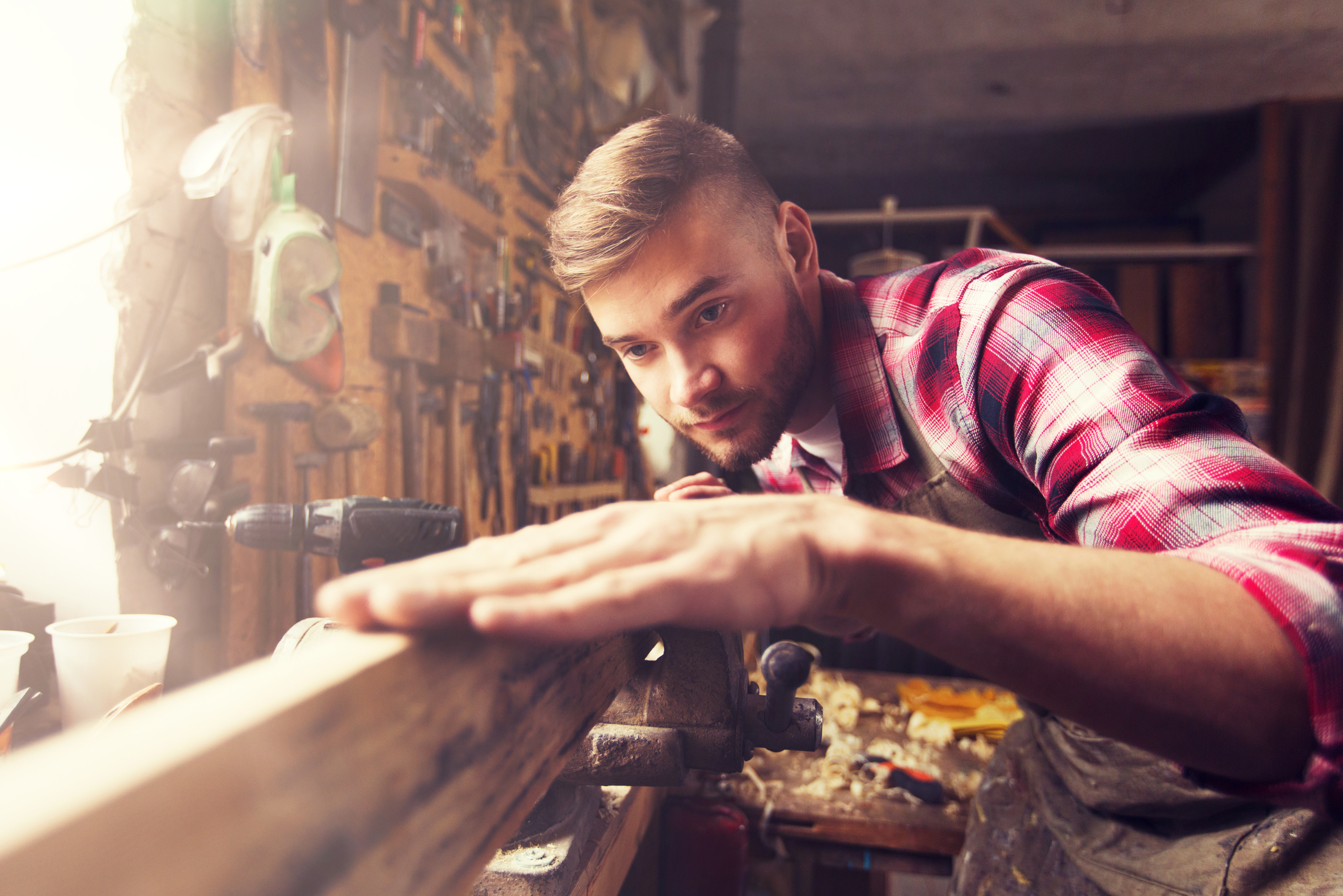 Person working on a piece of wood to make it perfect