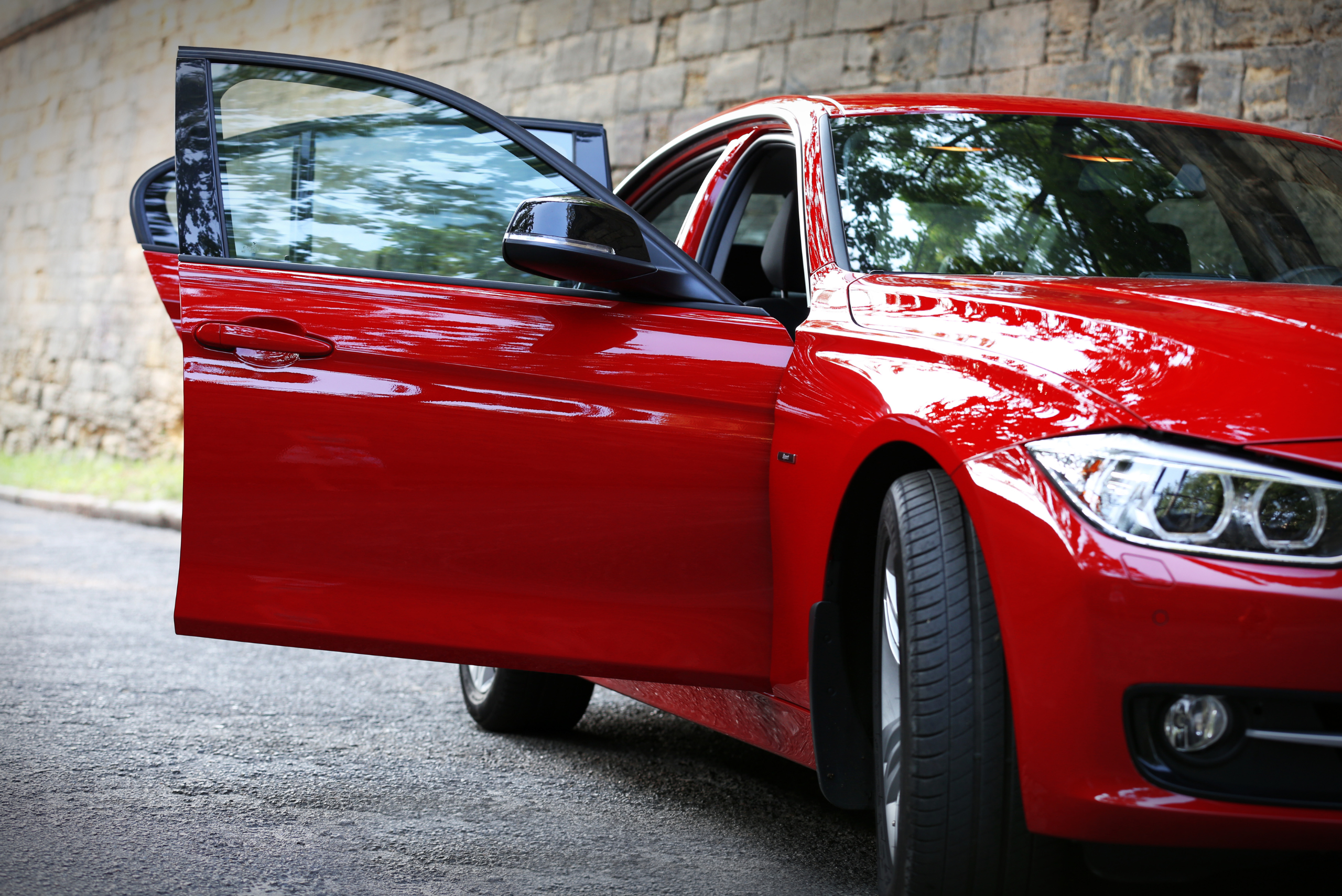 Red BMW with doors open to dry interior.