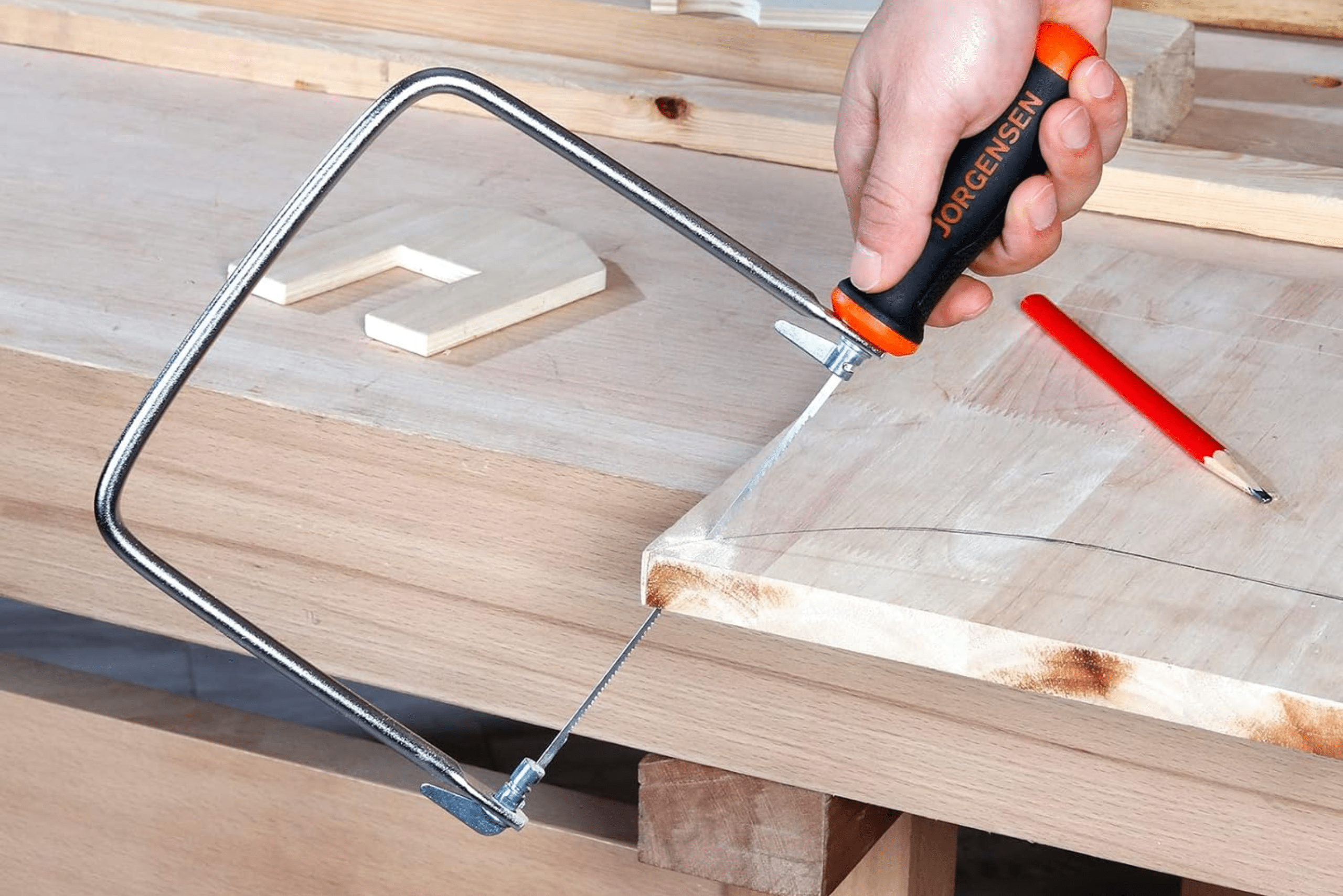 Coping saw cutting through a piece of wood.