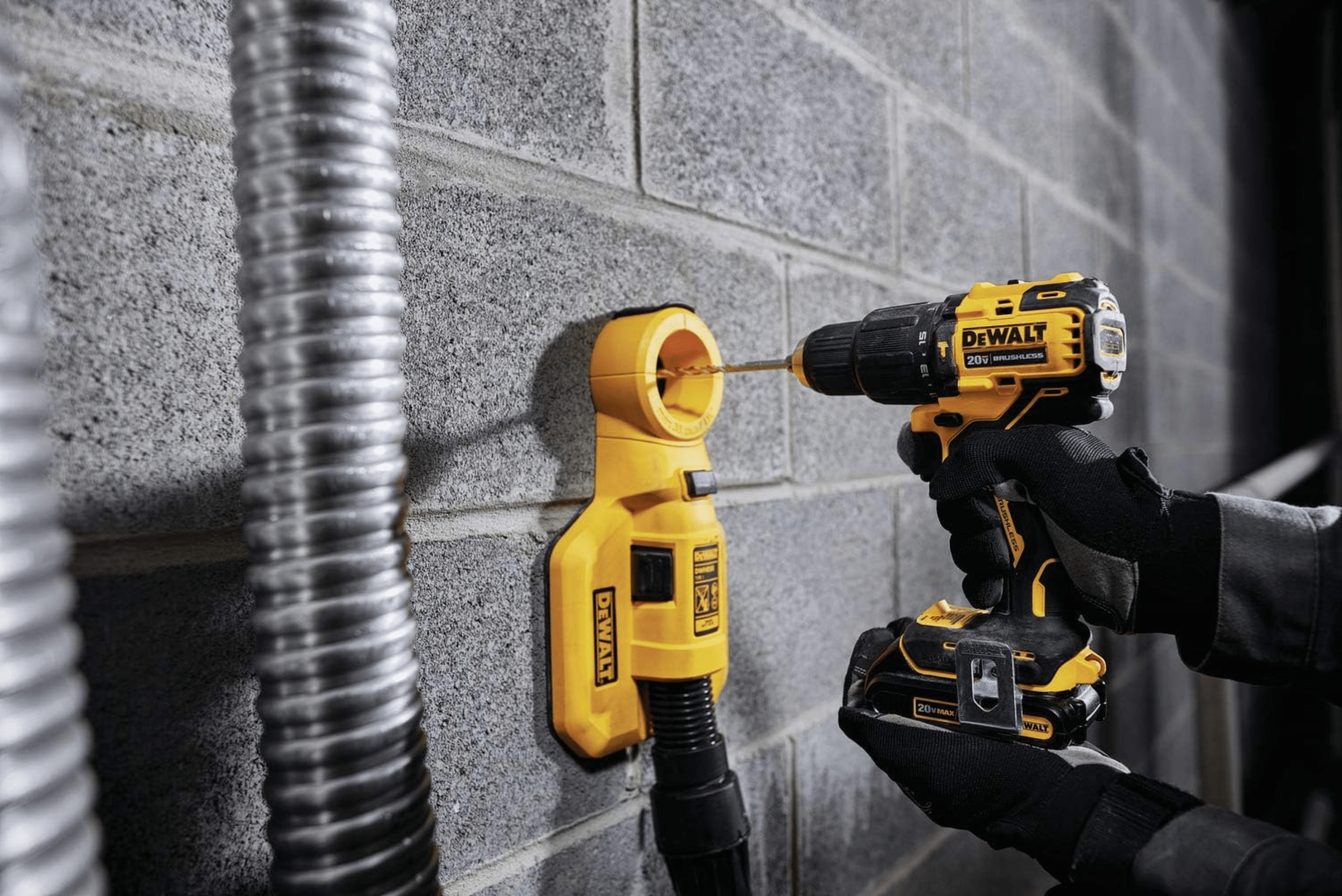 Person using DeWalt hammer drill on concrete wall.