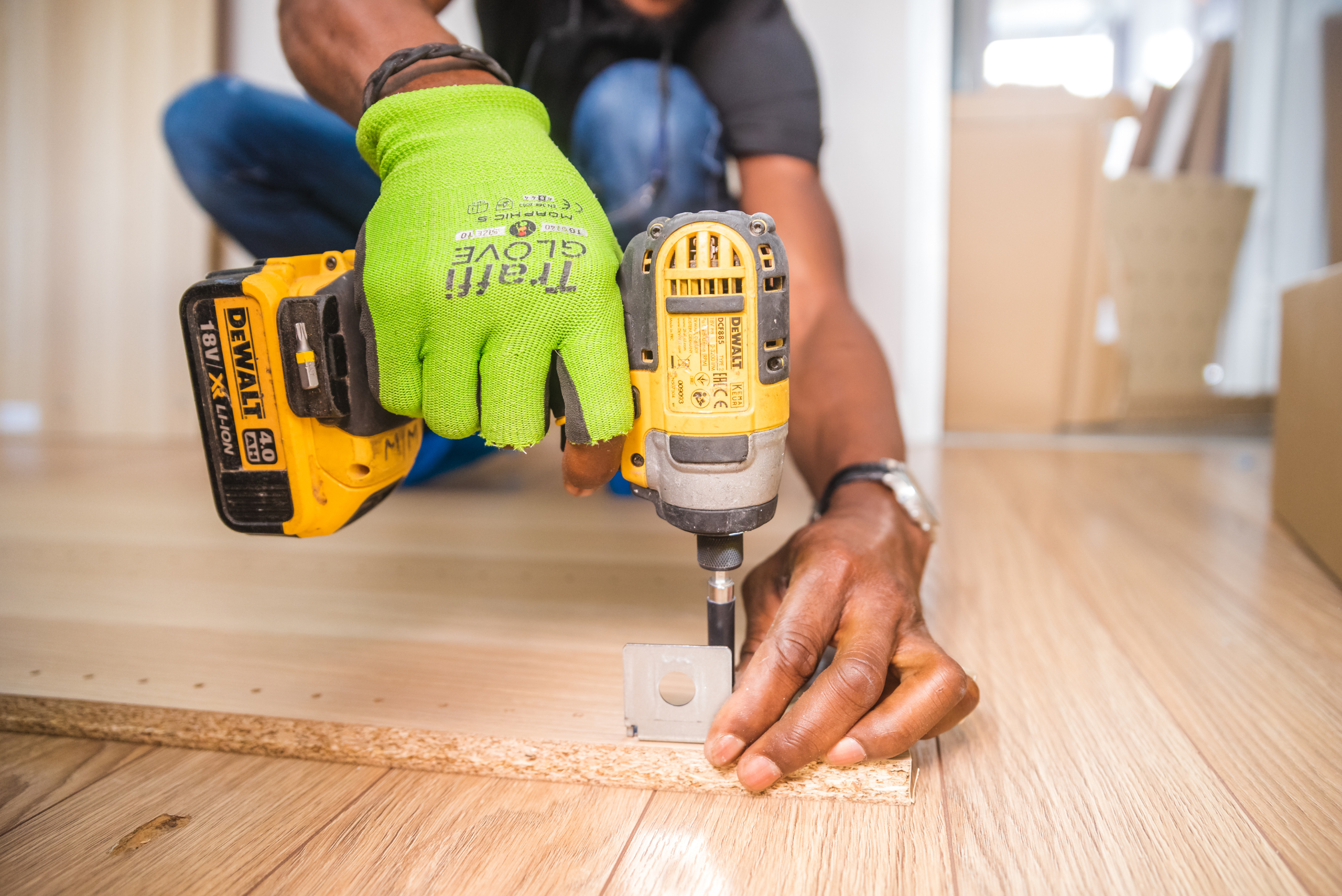 Person using impact driver to install screws.