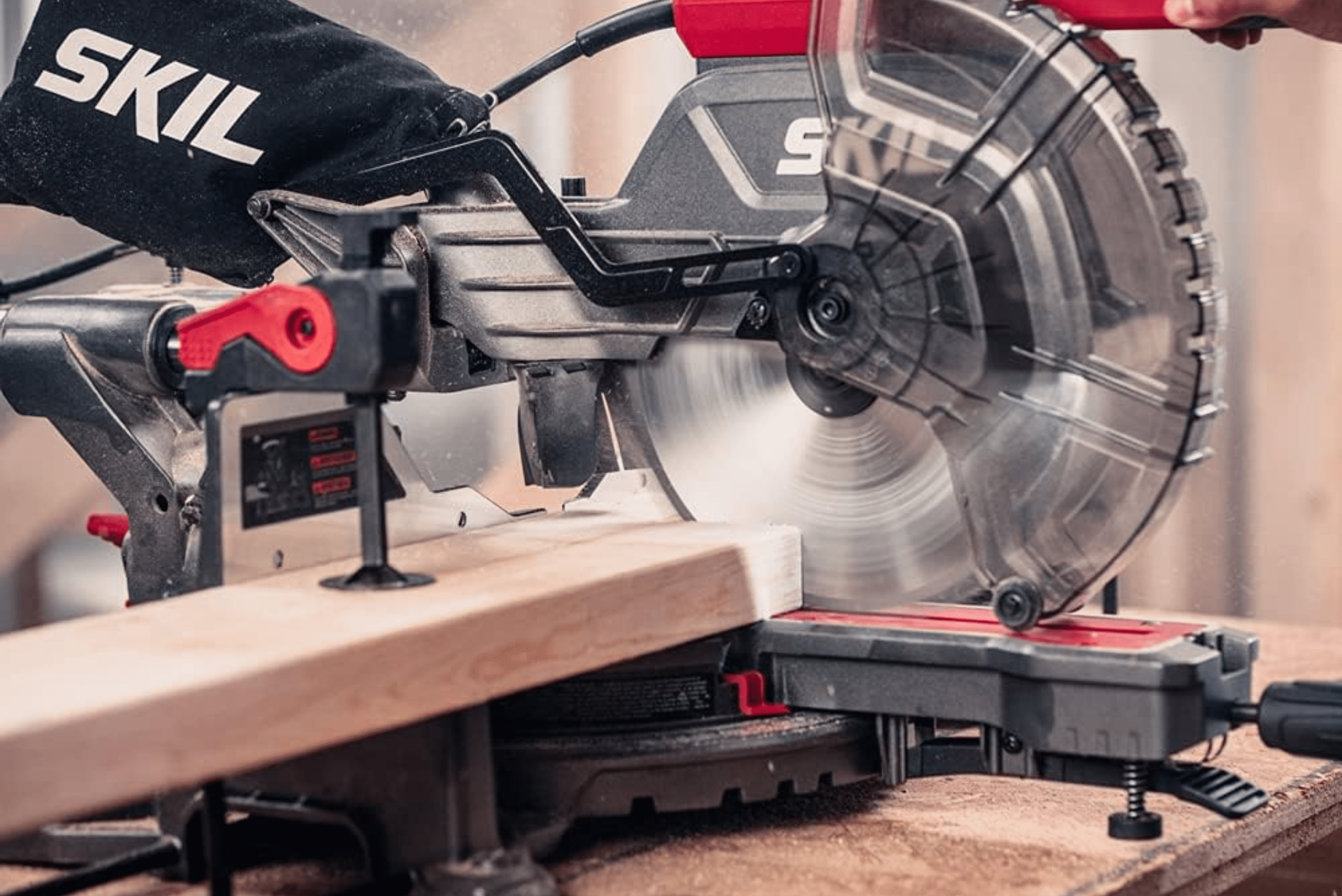 Miter saw cutting a wood board.