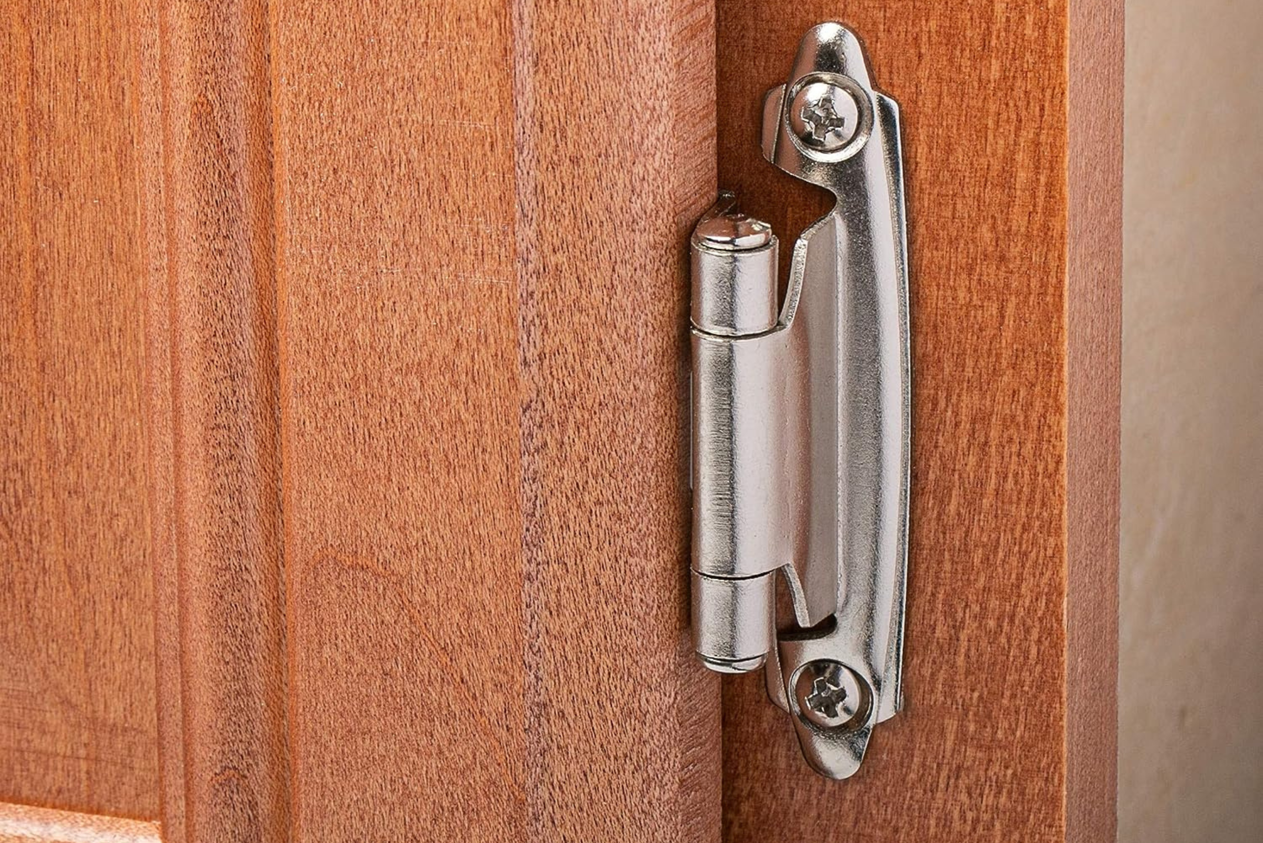 Closeup of overlay hinge on a cabinet.