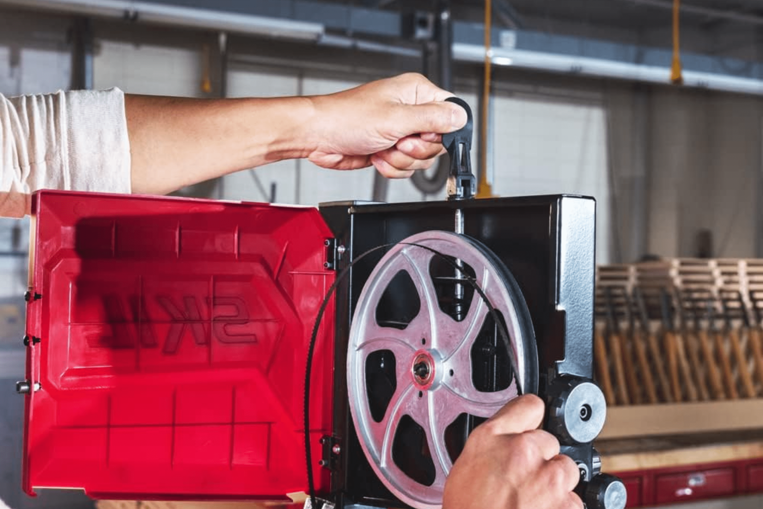 Person changing the blade on a band saw.