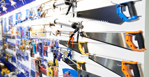 Saws displayed in a store on a shelf.