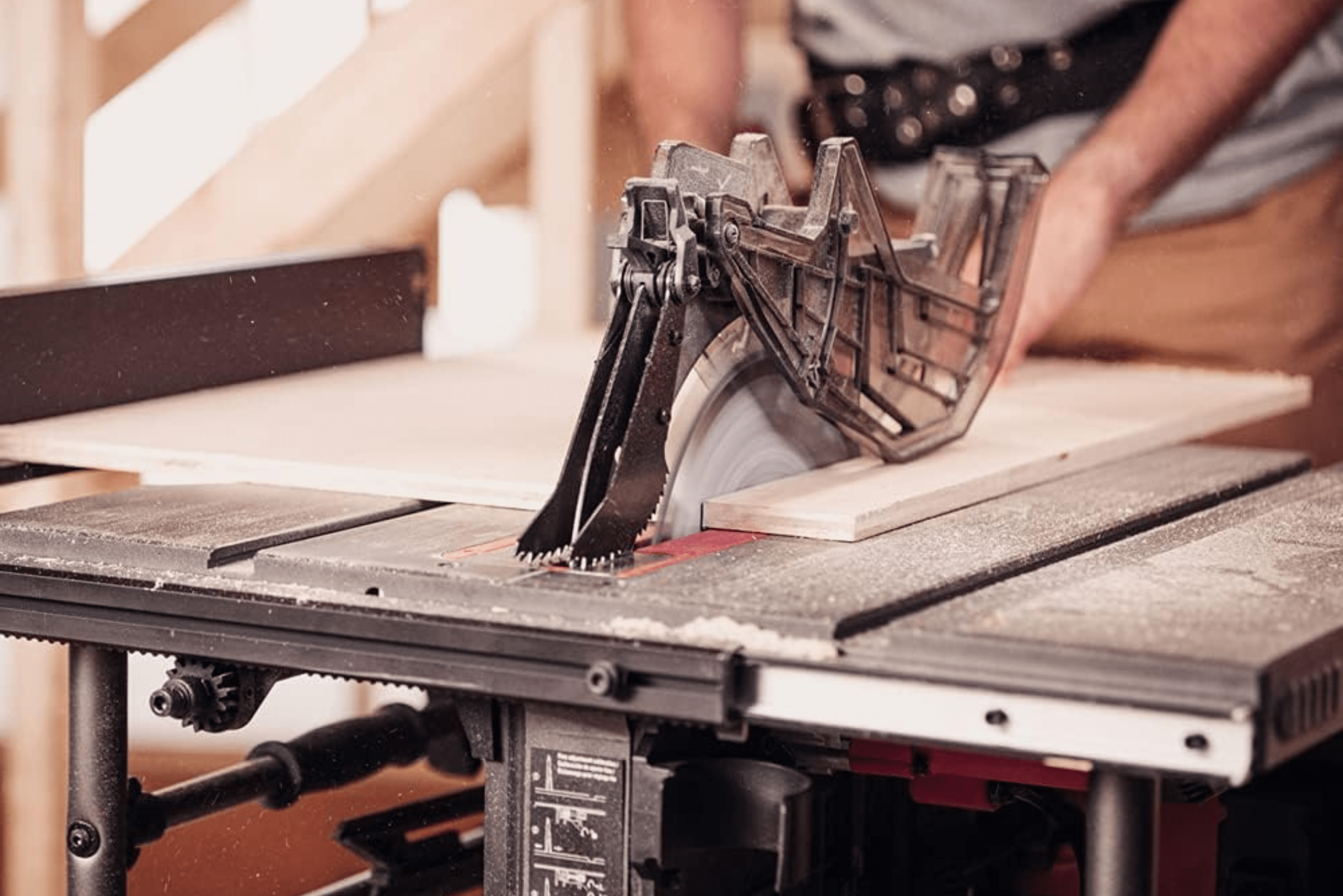 Wood being cut on a table saw.