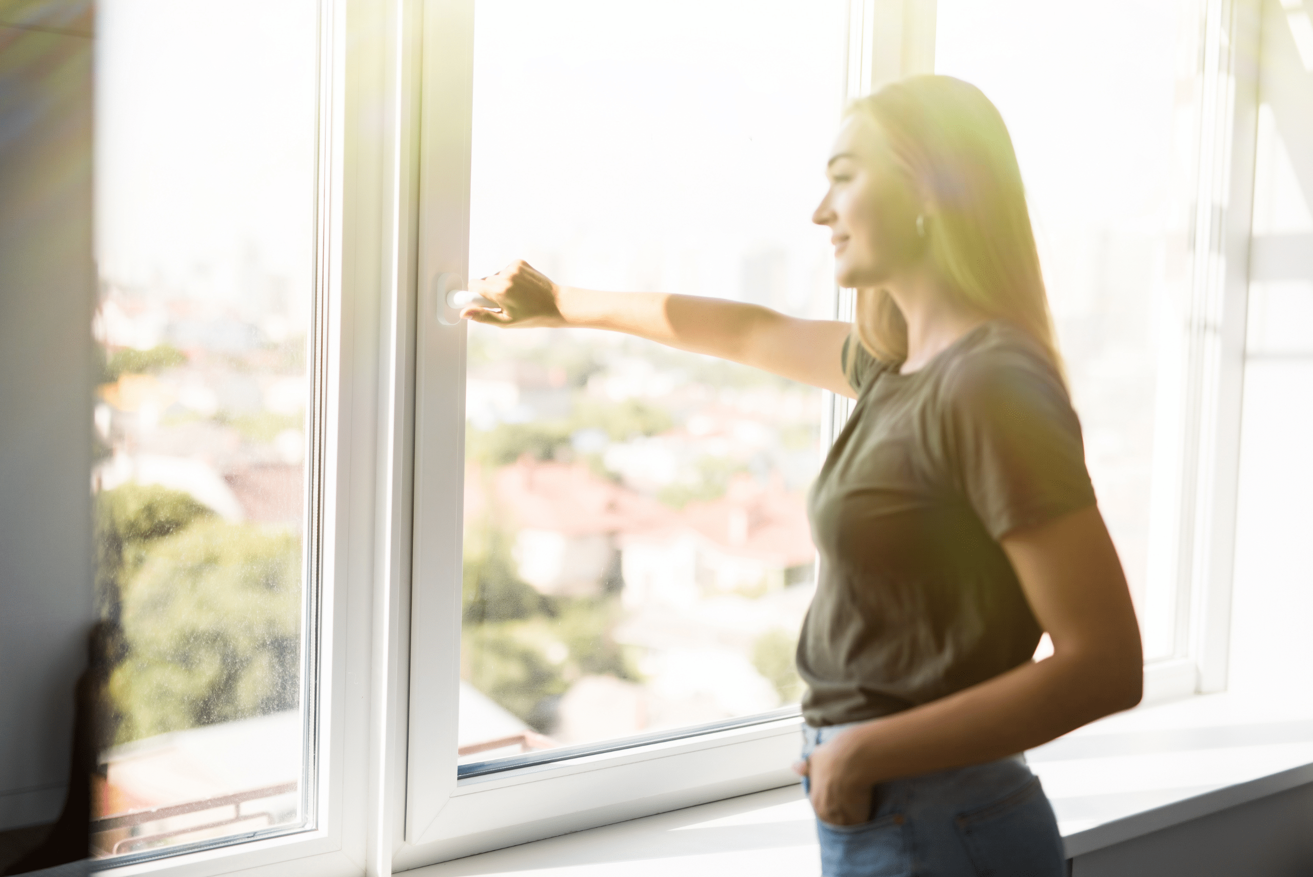 Person twists the window lock to open it.