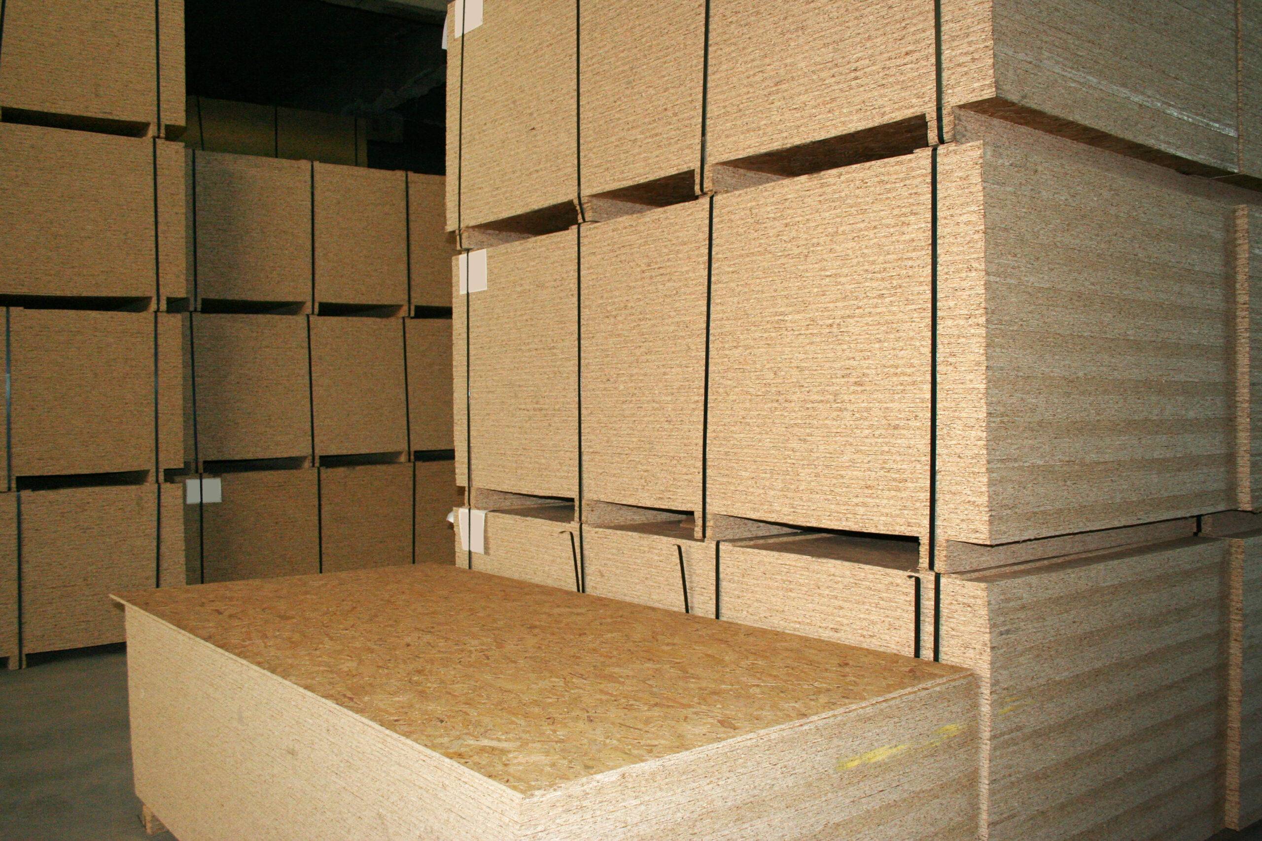 Stacks of OSB boards in storage.