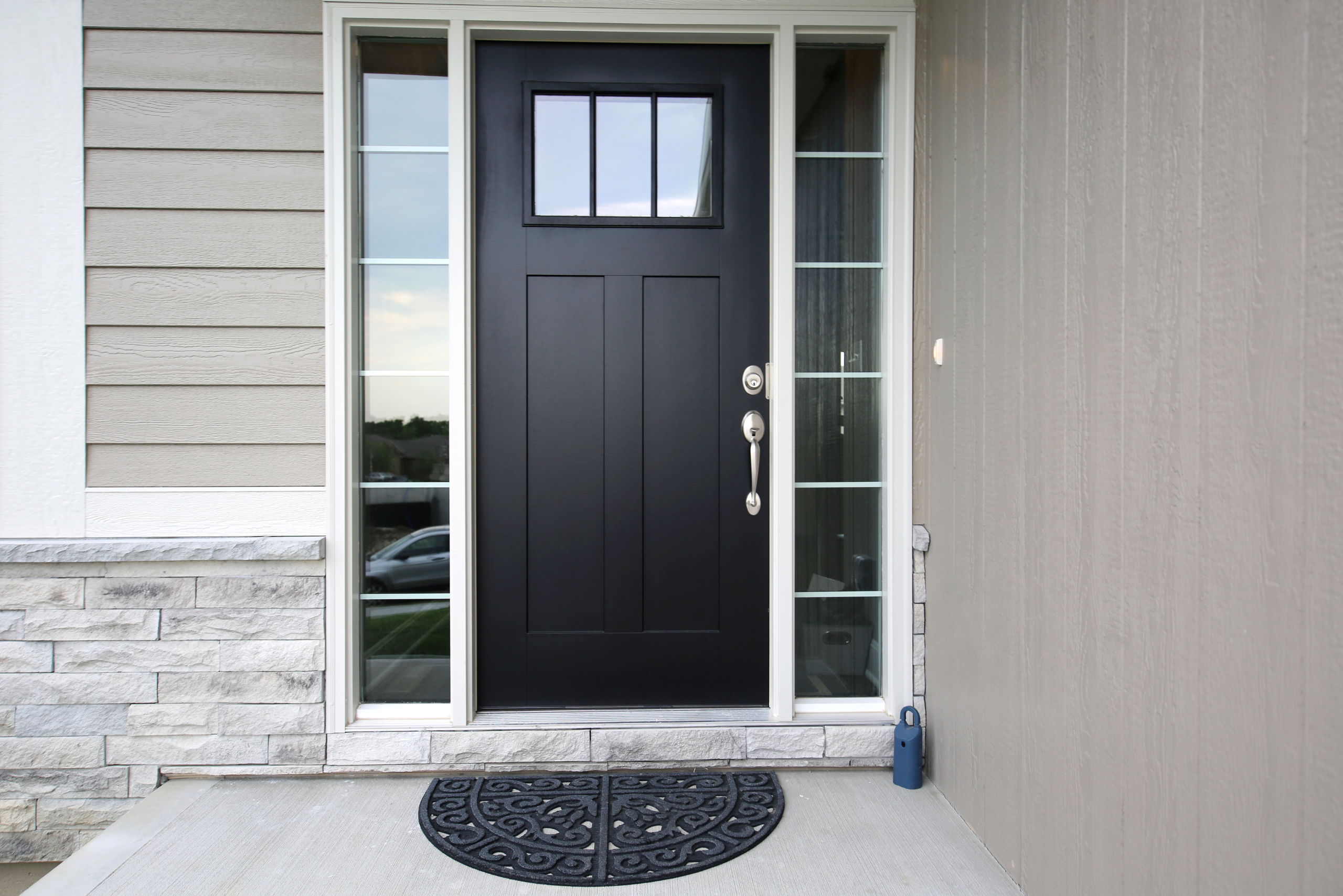 Modern front door that's painted black.