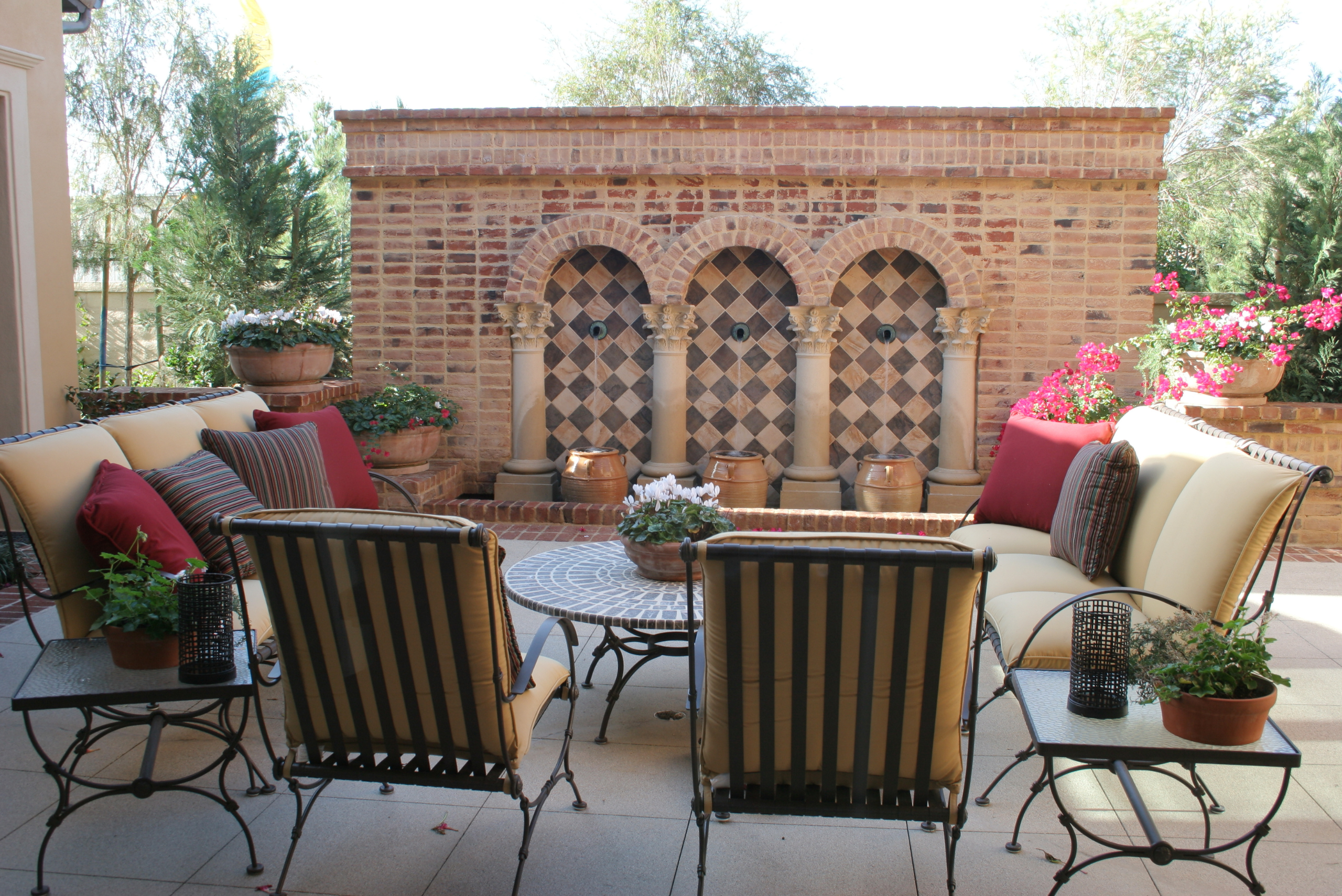 Unique backyard patio with seating and stone structure.