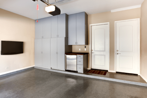 Modern garage with concealed shelving unit.