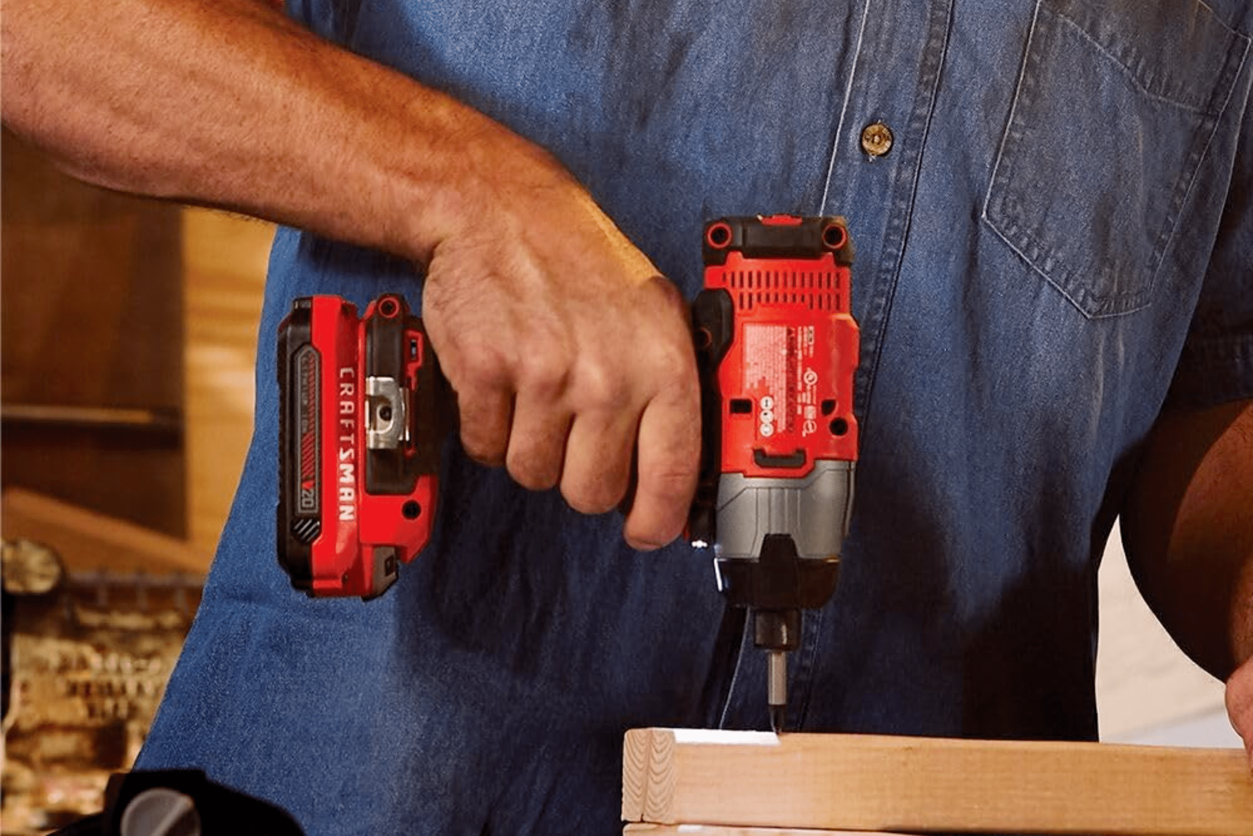 Person using impact driver to drive fastener into wood.