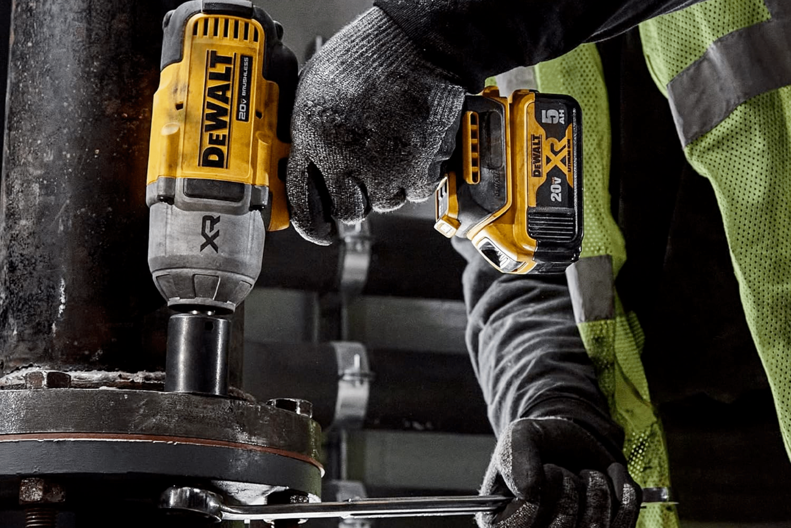 Worker using an impact wrench from DeWalt to tighten bolt.