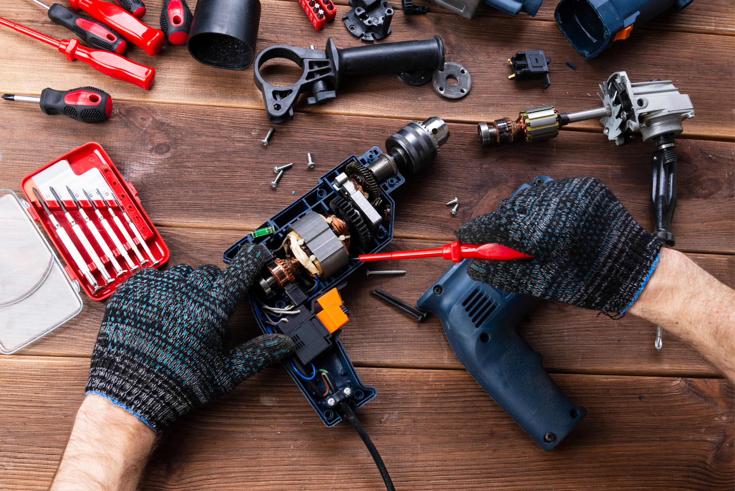 Person opening up a corded drill.