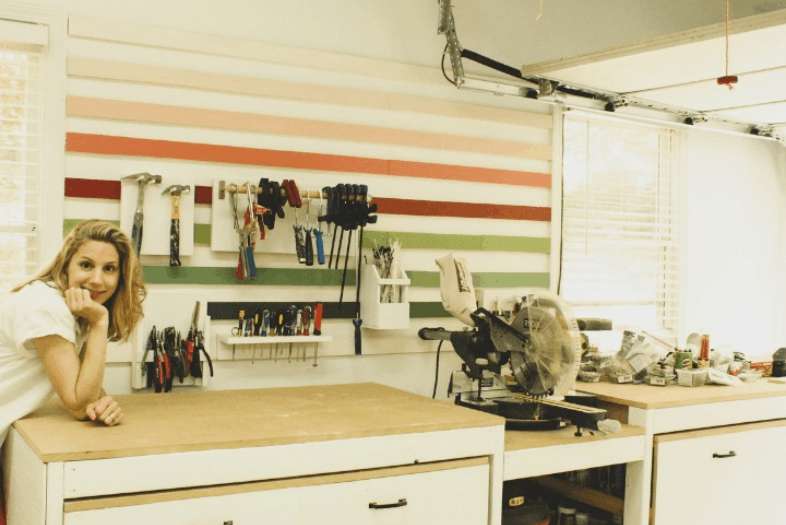 Work bench flanked by French cleat wall with colorful cleats.