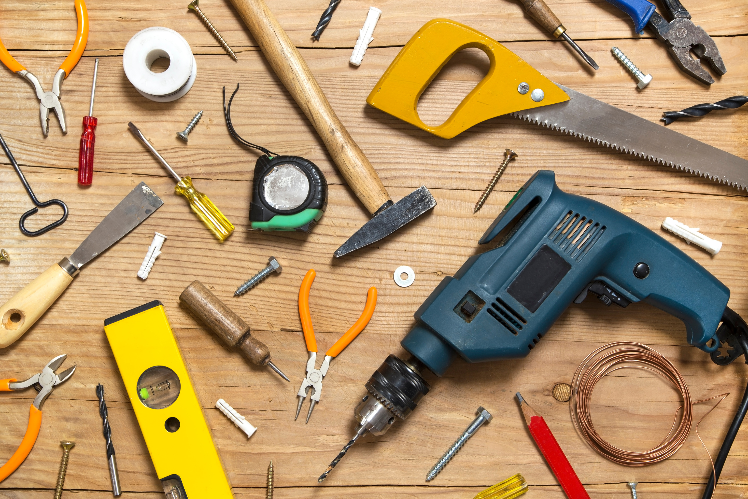 Assortment of tools on a wooden surface.