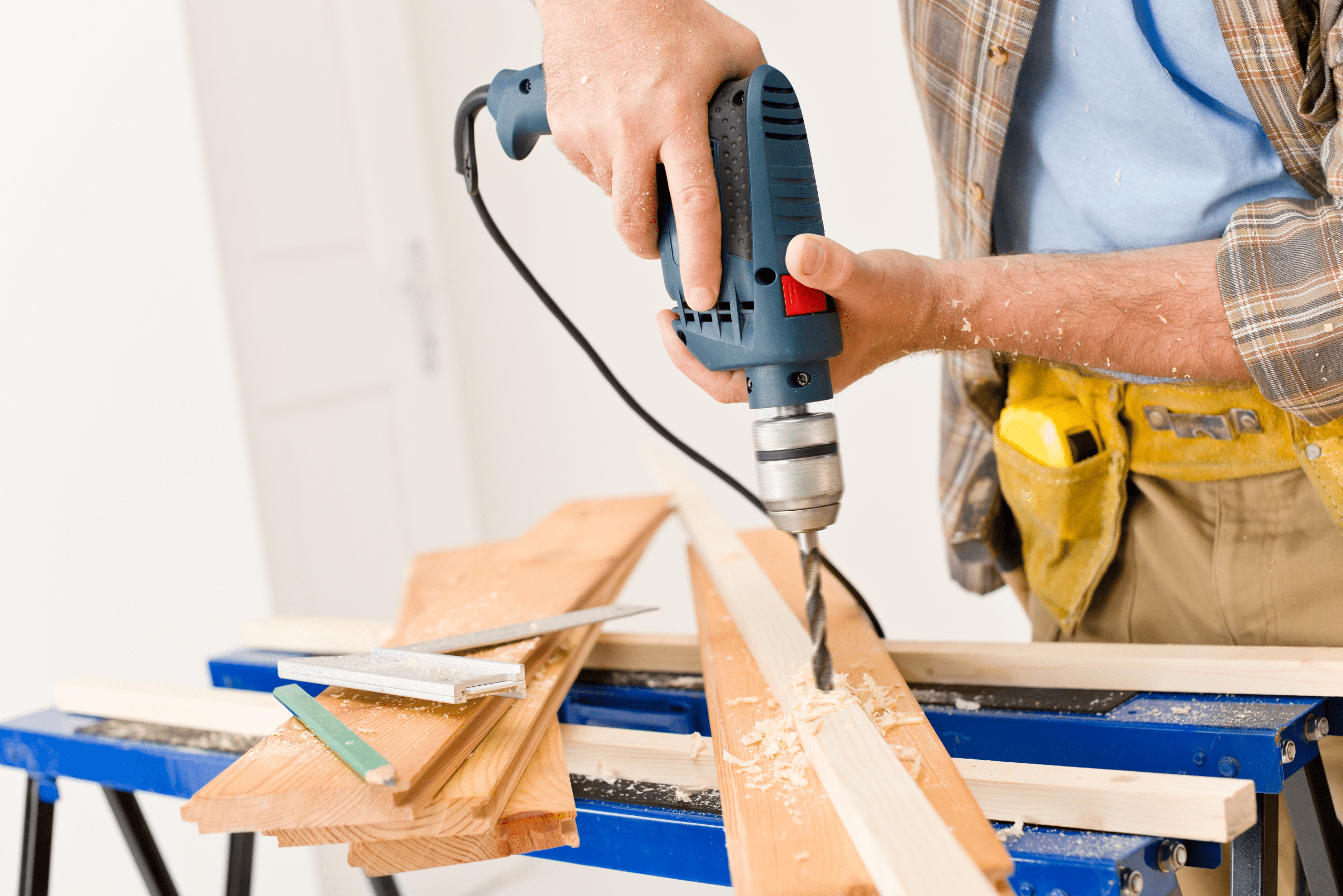 Person using drill on wood boards.