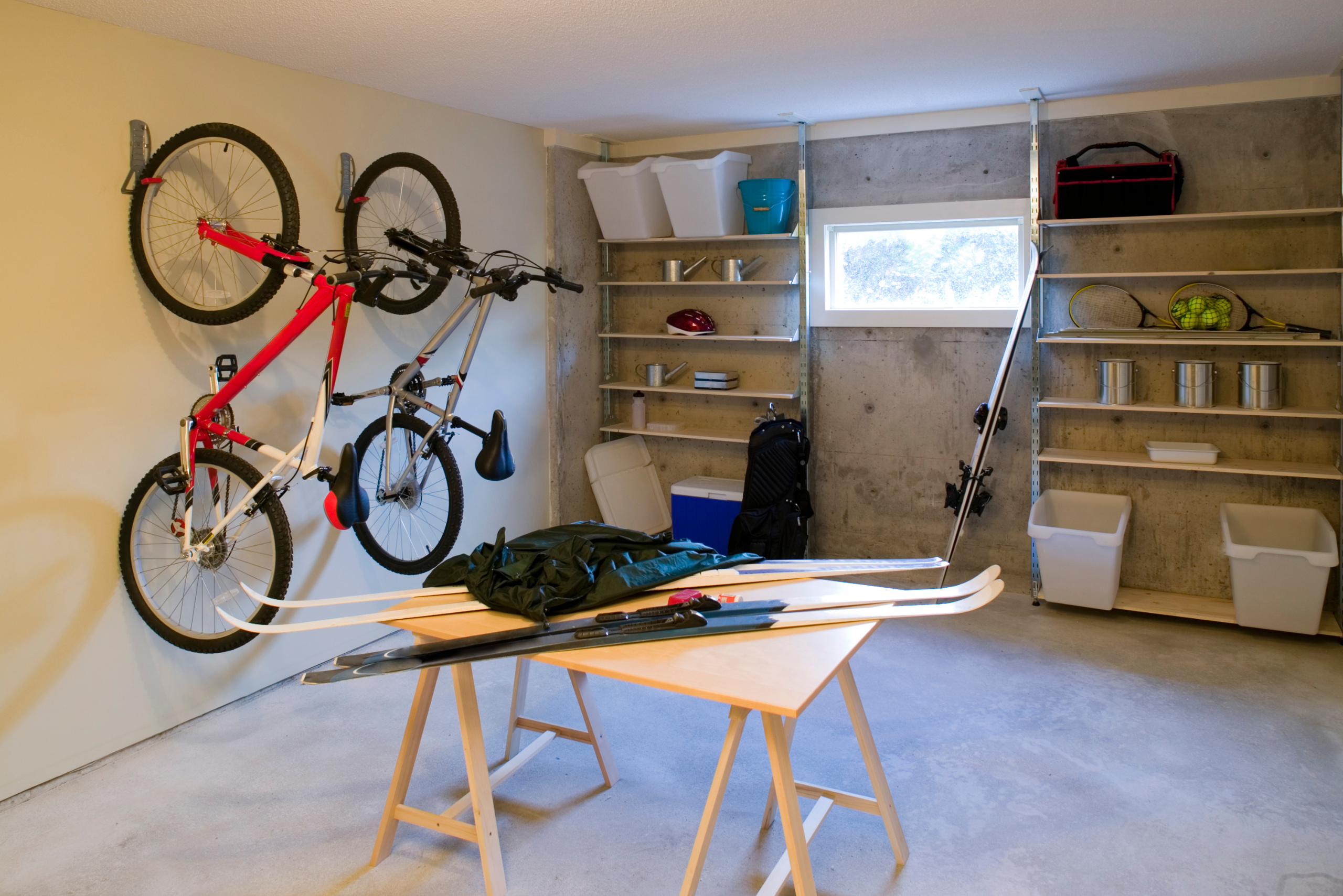 Modular shelving units between a window in a garage.