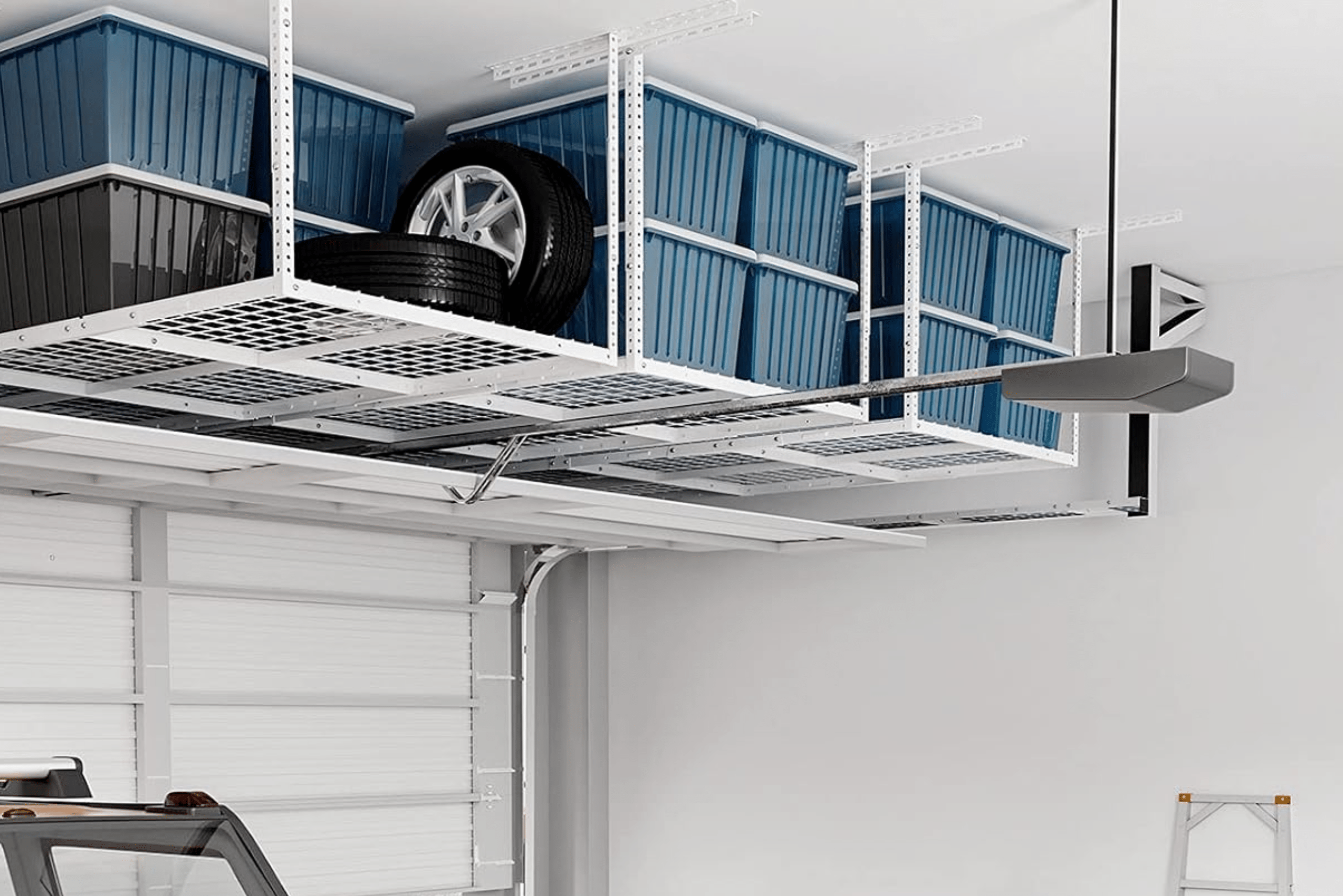 Overhead metal storage shelf holding bins and tires.