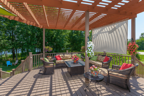 Pergola shading a patio set and deck.